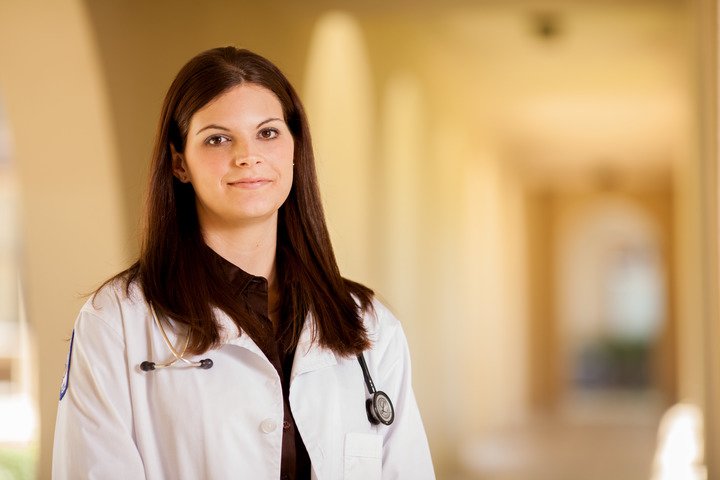 A female CBU graduate nursing student standing in a hallway